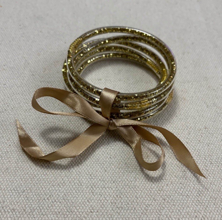 Set of gold glitter plastic tube bangle Bracelets.