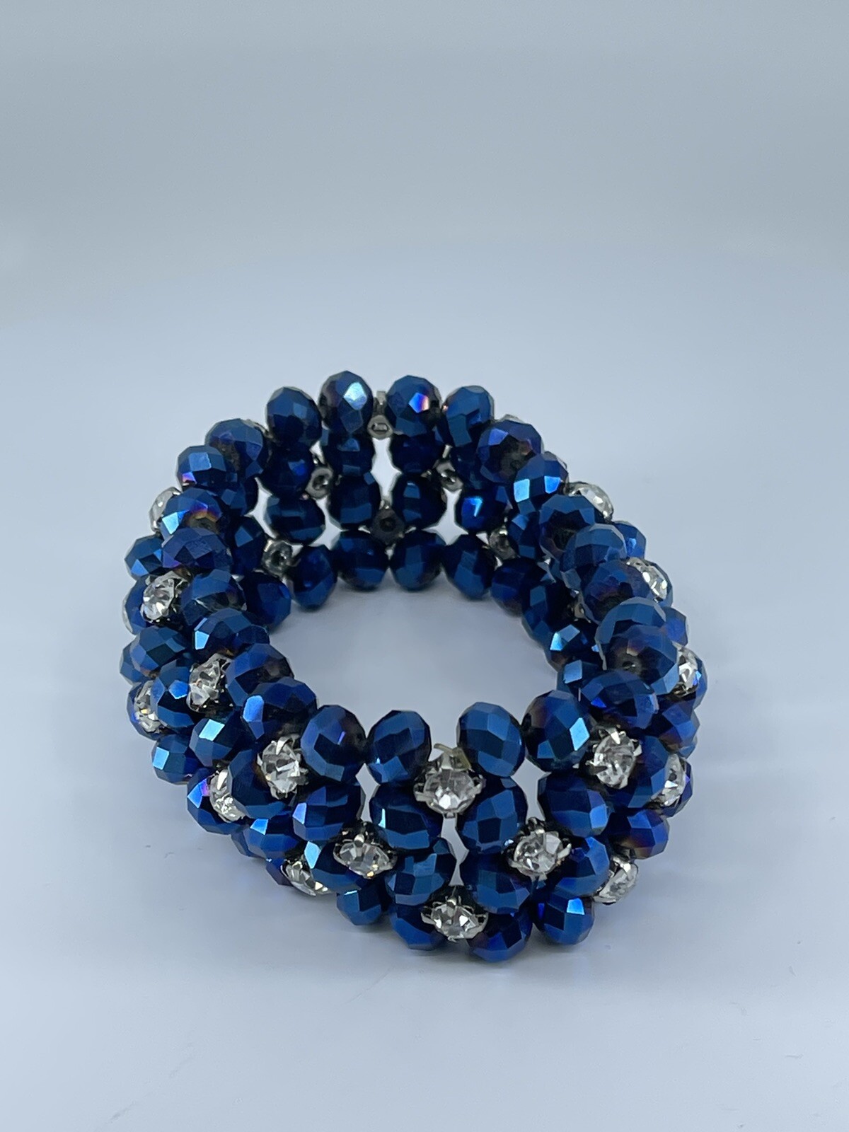 Blue beaded stretch Bracelet with white colorless prong set rhinestones 6.75″
