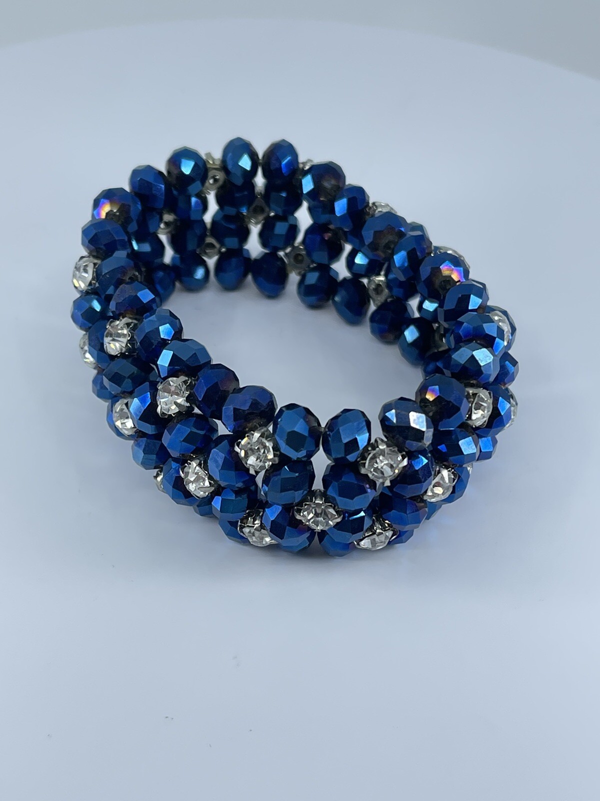 Blue beaded stretch Bracelet with white colorless prong set rhinestones 6.75″