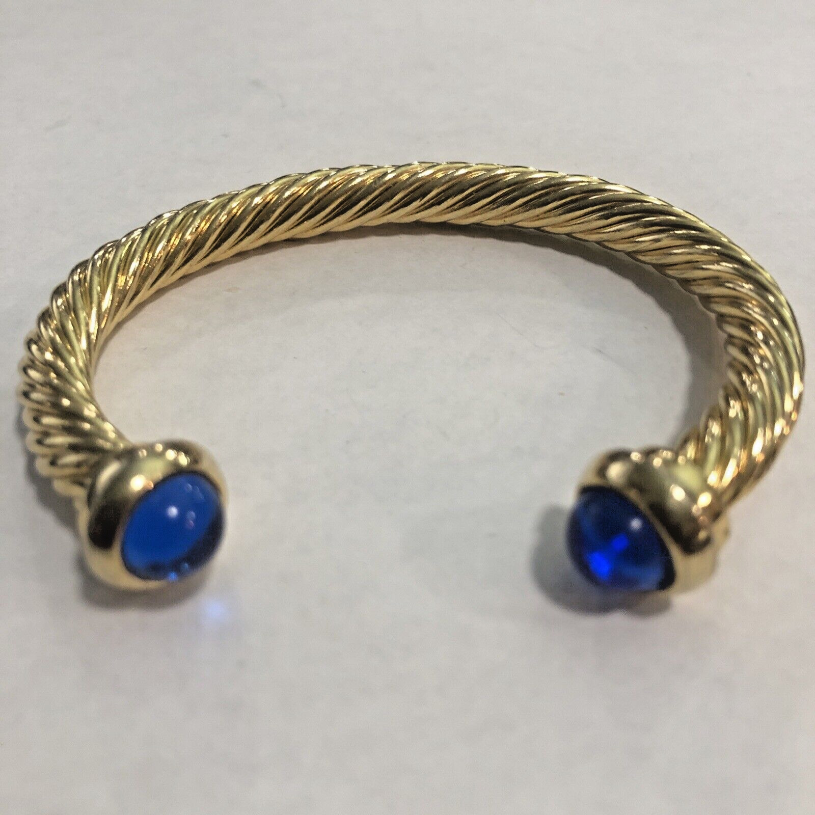 Gold Tone Bangle With Round Cabochon Cut Blue Stone