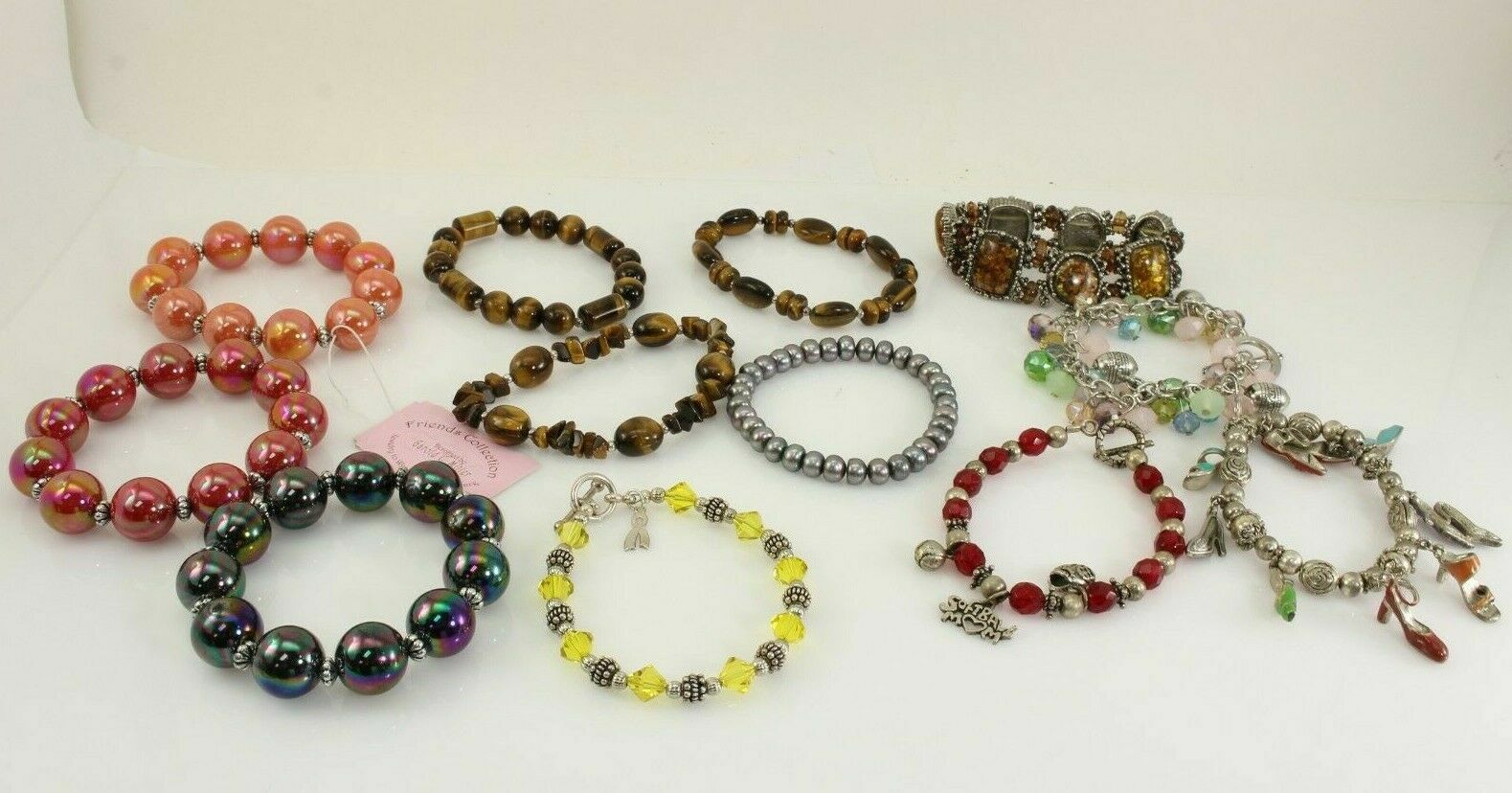 LOT OF 12 COSTUME JEWELRY BEADED BRACELETS BROWN, RED, ORANGE, SILVER, & GREEN