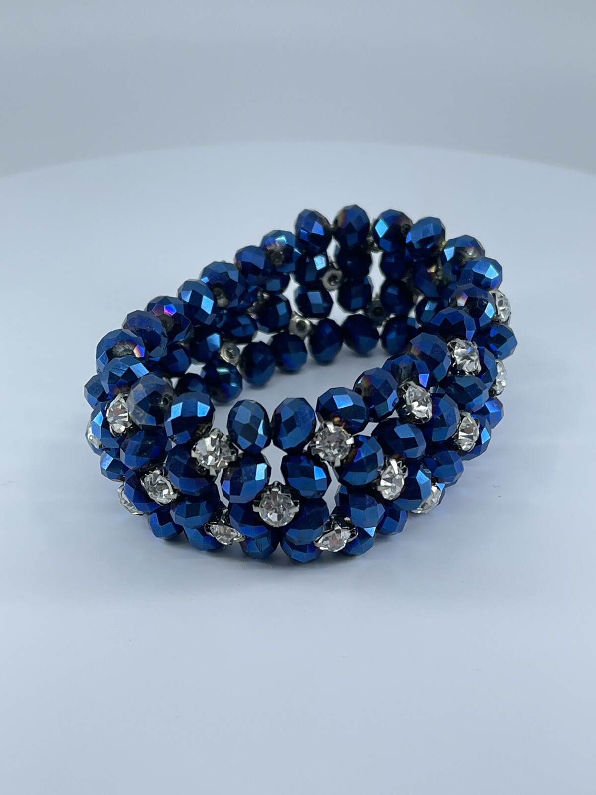 Blue beaded stretch Bracelet with white colorless prong set rhinestones 6.75″