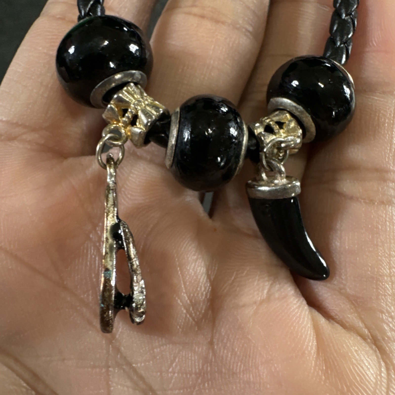 Bracelet black braided cord, silver tone charms, toggle clasp