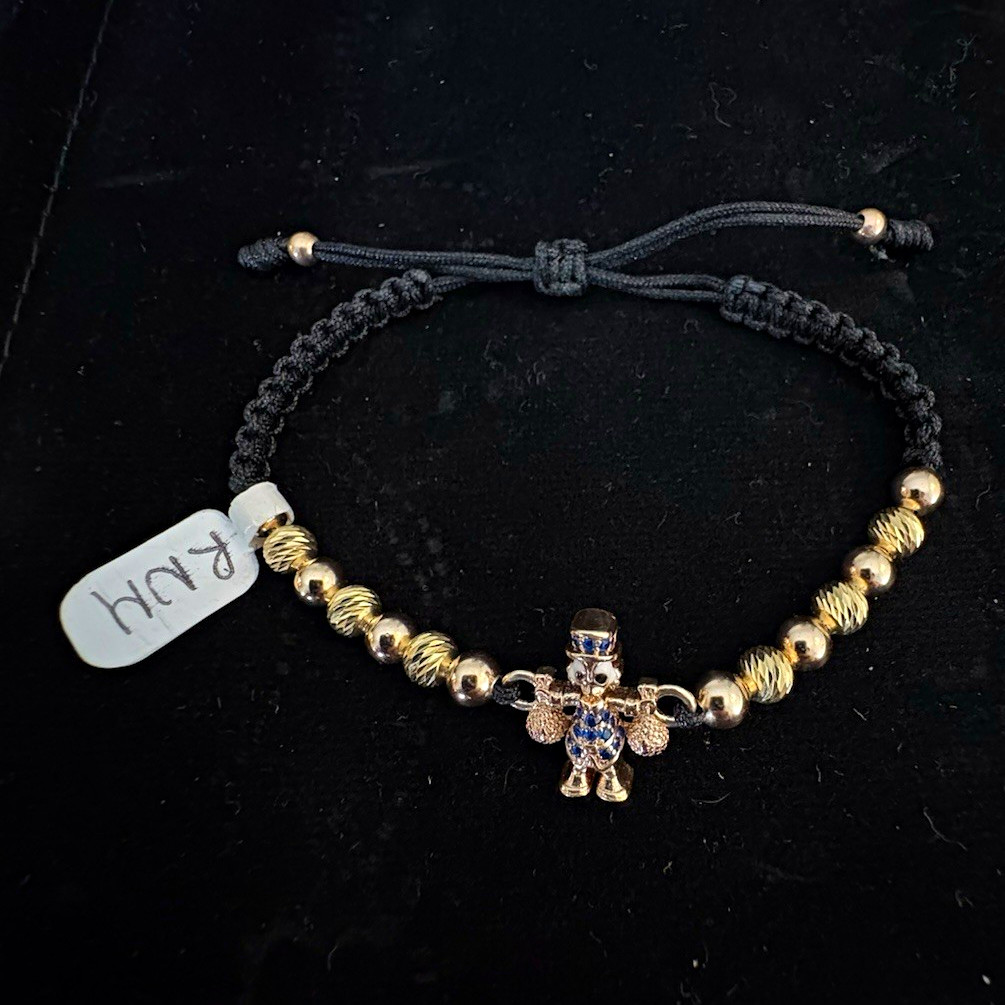 Adjustable black cord bracelet featuring 18-karat Italian gold-plated spheres
