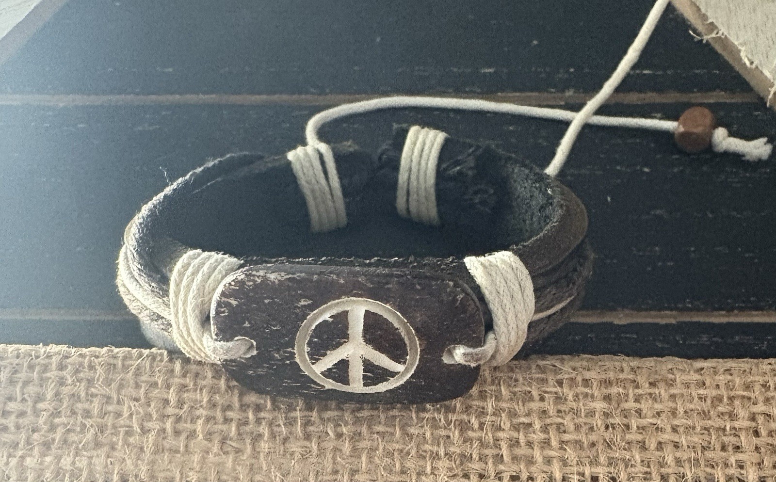 brown leather cord cuff bracelet . peace sign charm . adjustable tie closure