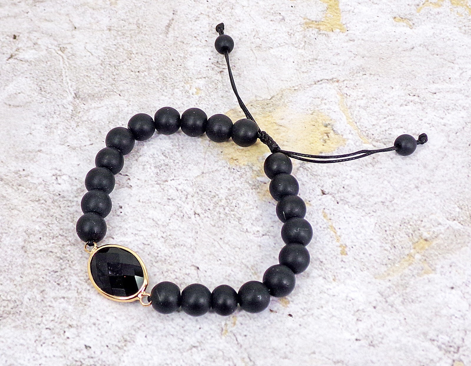 Black stone bead bracelet with black glass bead and adjustable size tie back New
