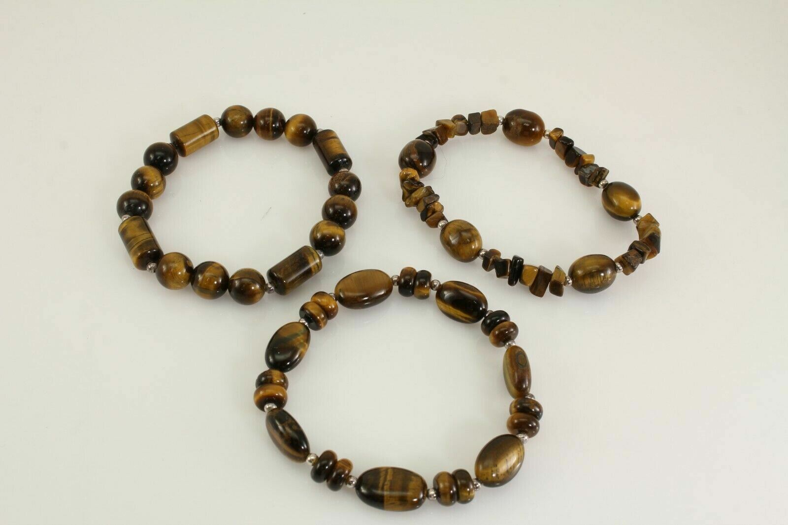 LOT OF 12 COSTUME JEWELRY BEADED BRACELETS BROWN, RED, ORANGE, SILVER, & GREEN