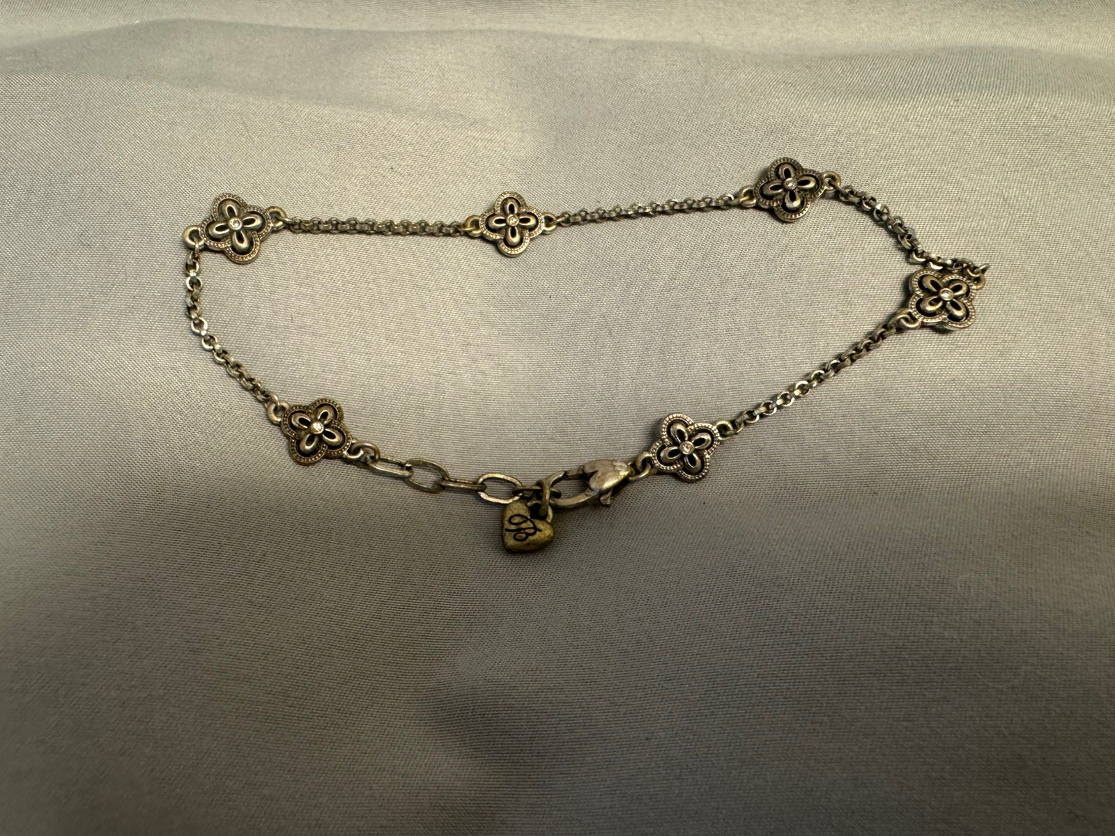 This is a Brighton Ferrara bracelet with clover-shaped stations & crystal accent