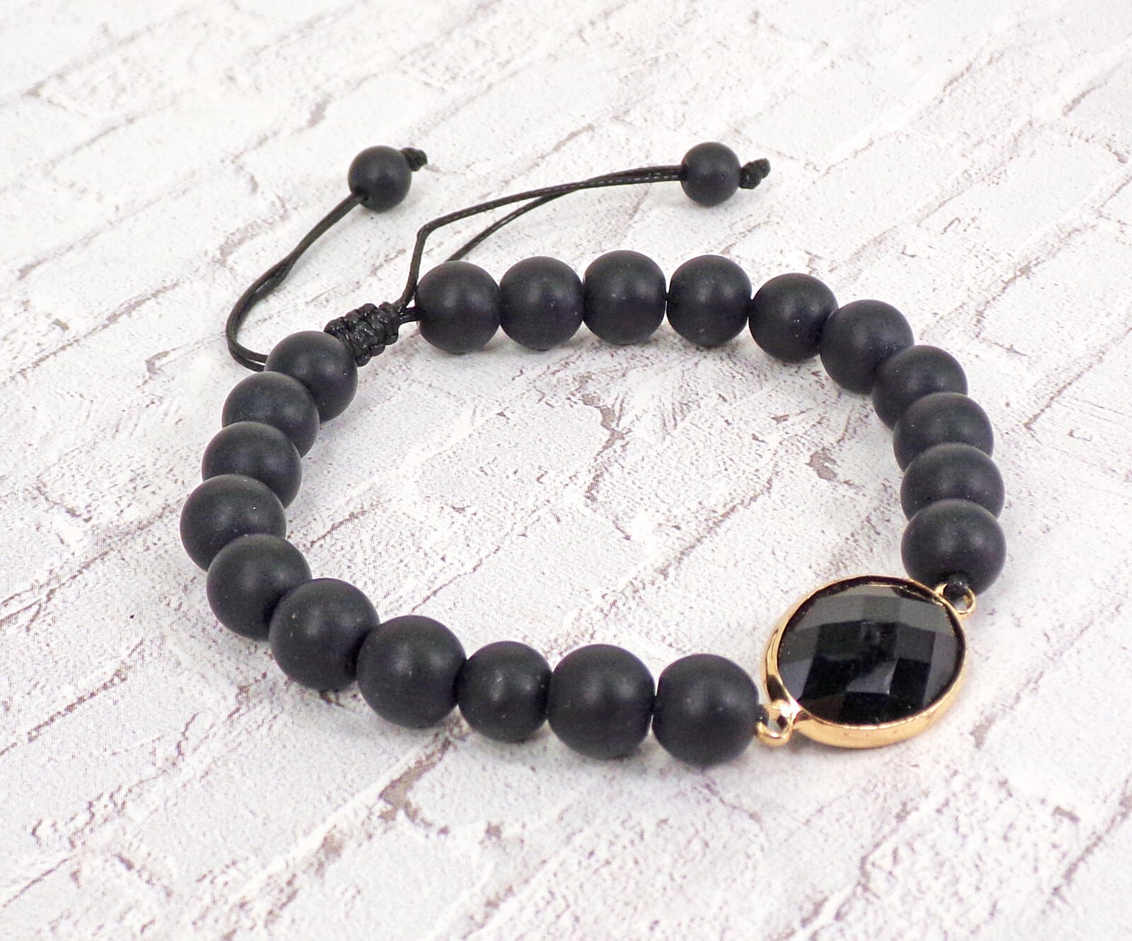 Black stone bead bracelet with black glass bead and adjustable size tie back New