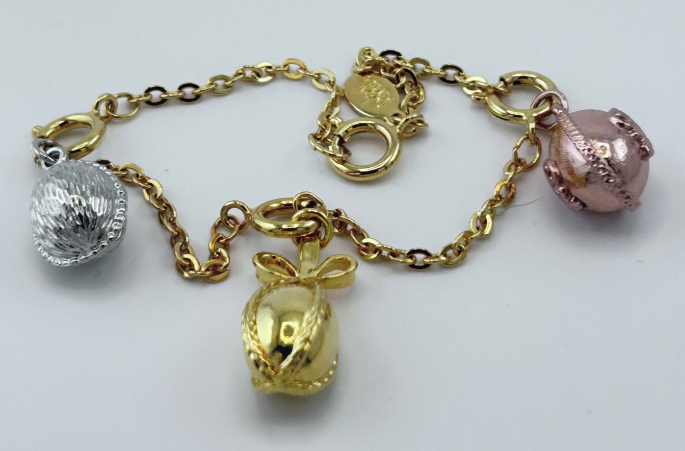 Joan Rivers Vintage gold, silver, and rose tone Charms Bracelet