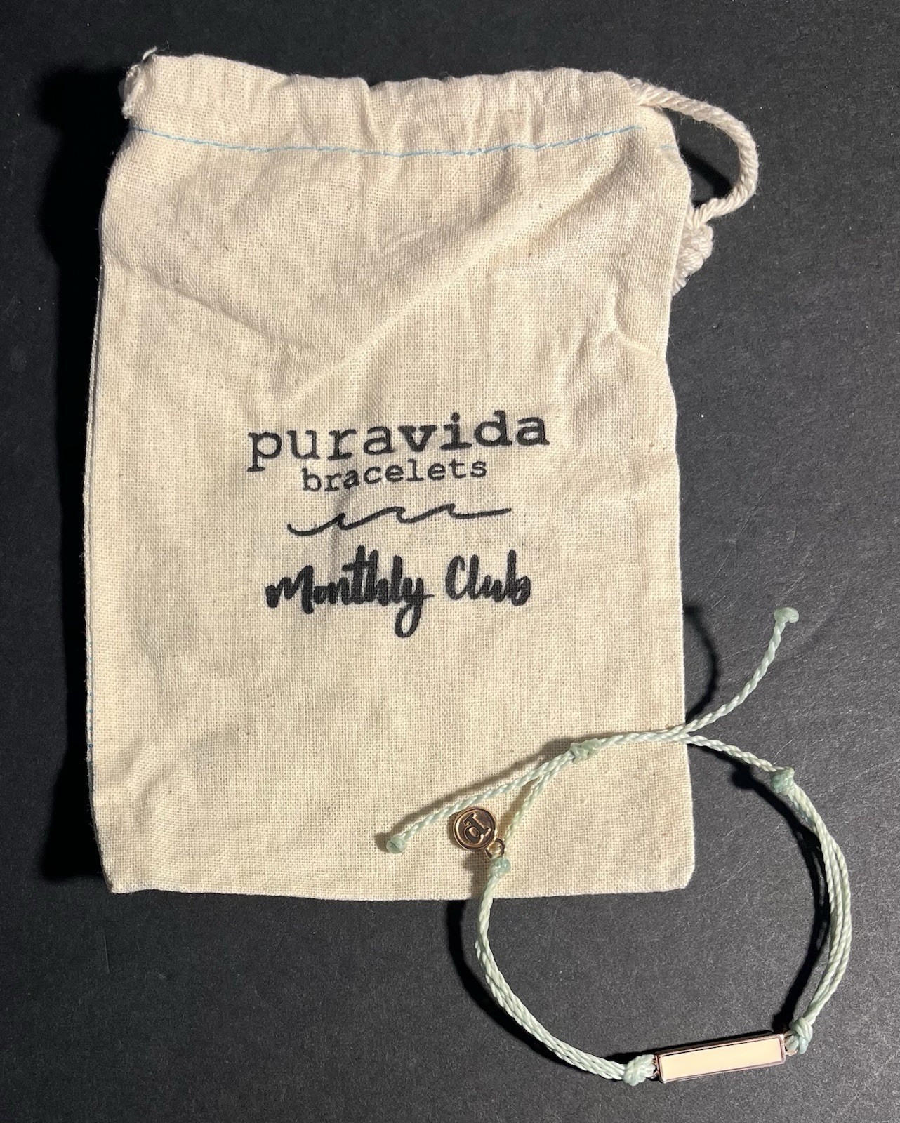 Pura Vida Bracelet Aqua Unbraided Cord W/ Cream Enameled Gold Rectangle Charm
