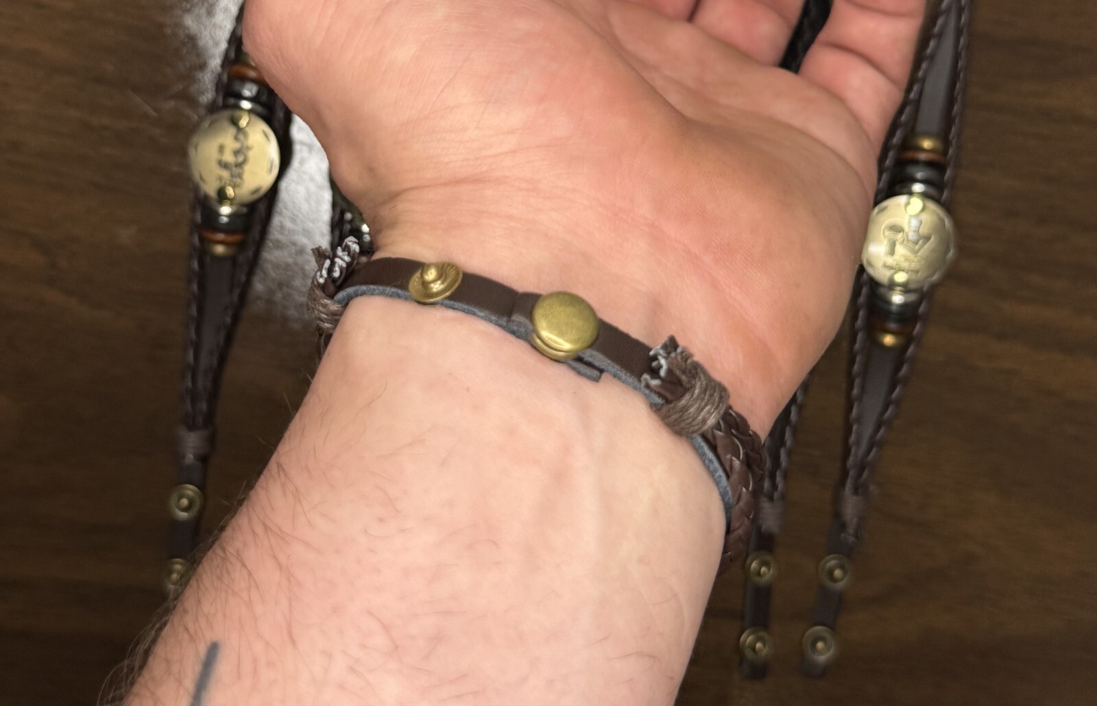Zodiac themed leather braided bracelet with metallic details