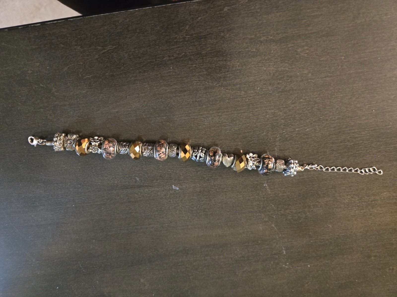 silver bead pandora like bracelet with gold tones