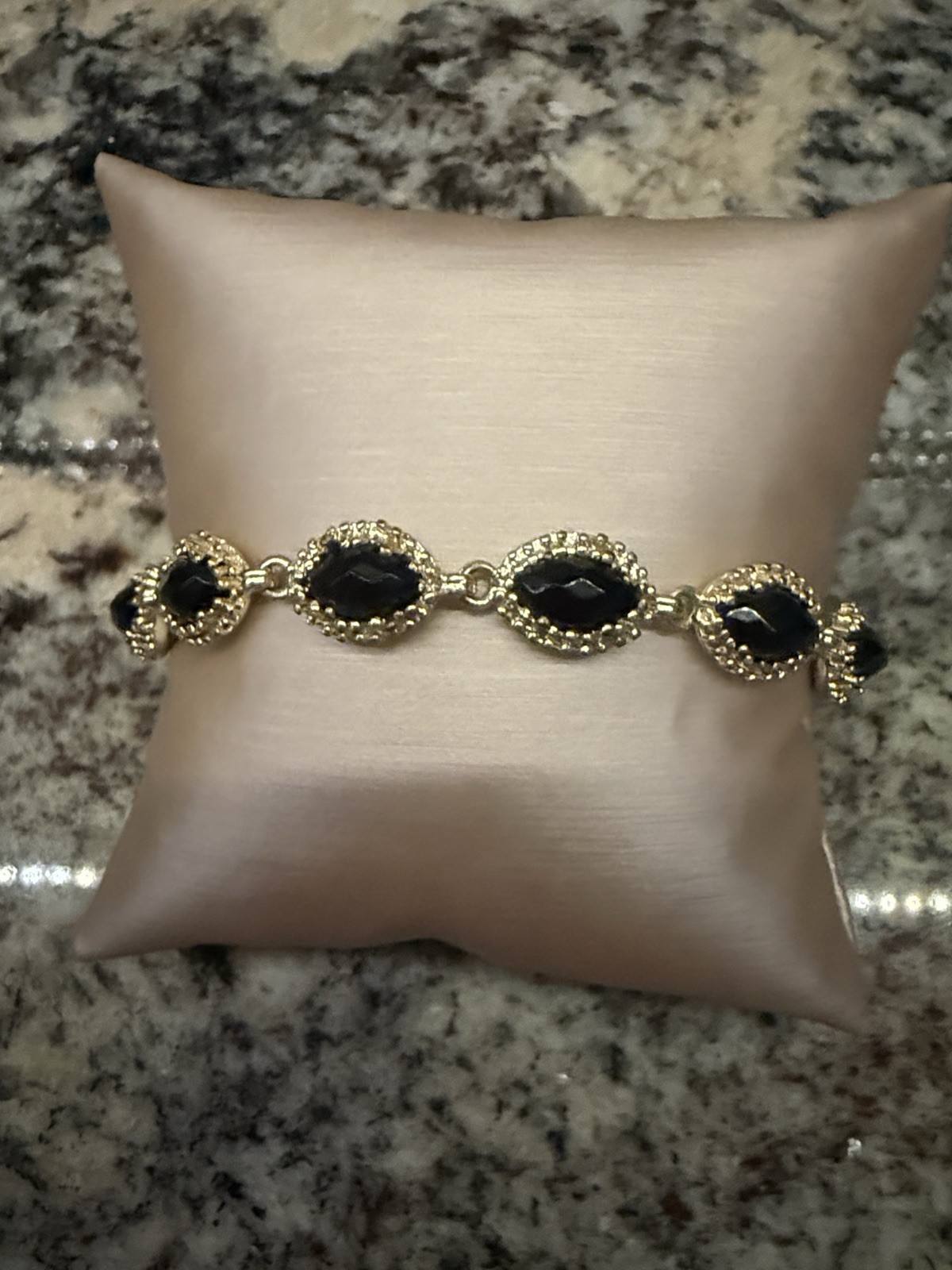 Retiree Kendra Scott Gold Jana bracelet with black onyx stones