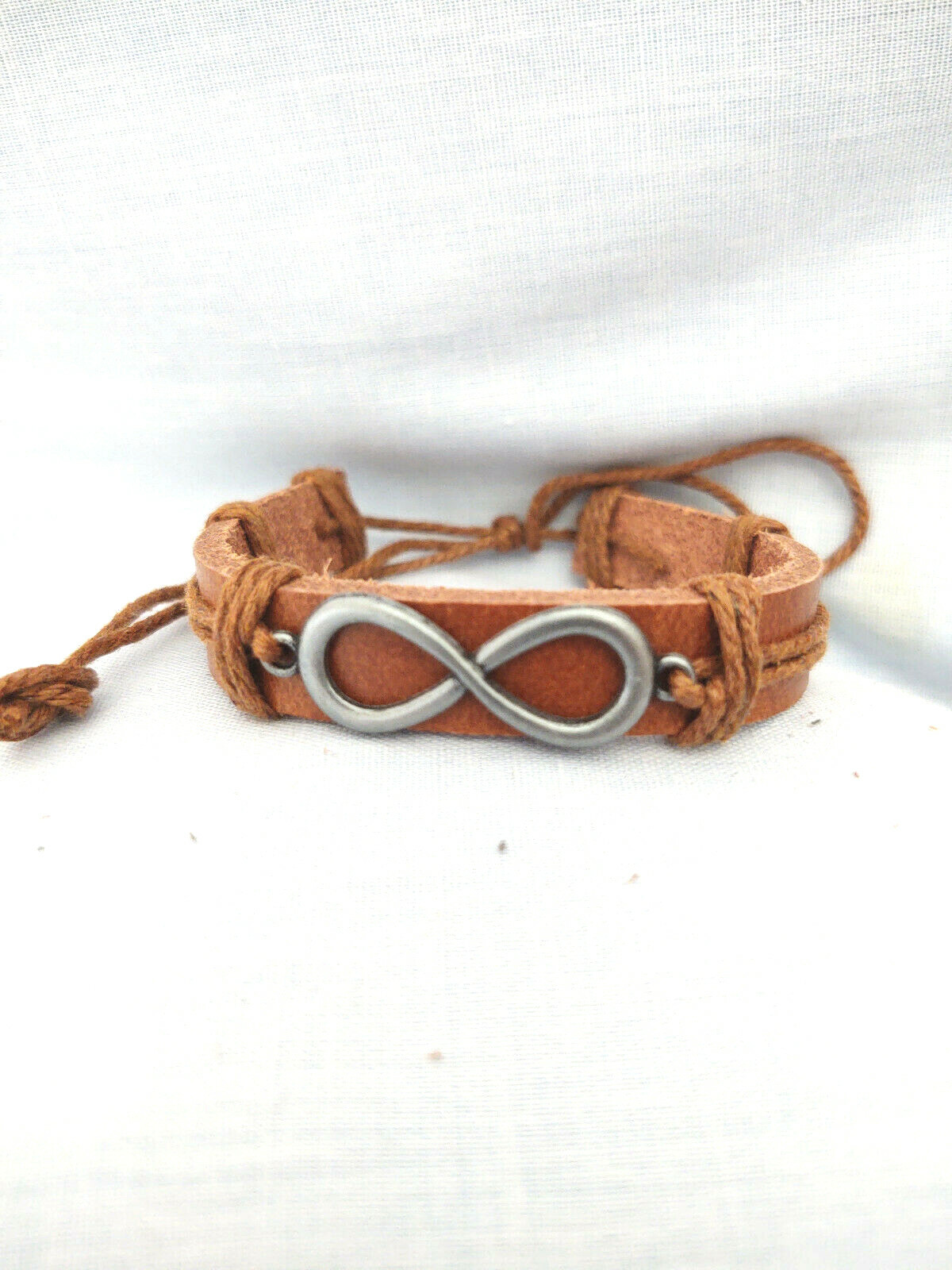 INFINTY FIGURE 8 SYMBOL ON RUSTIC MEDIUM BROWN LEATHER SLIDER CORD BRACELET