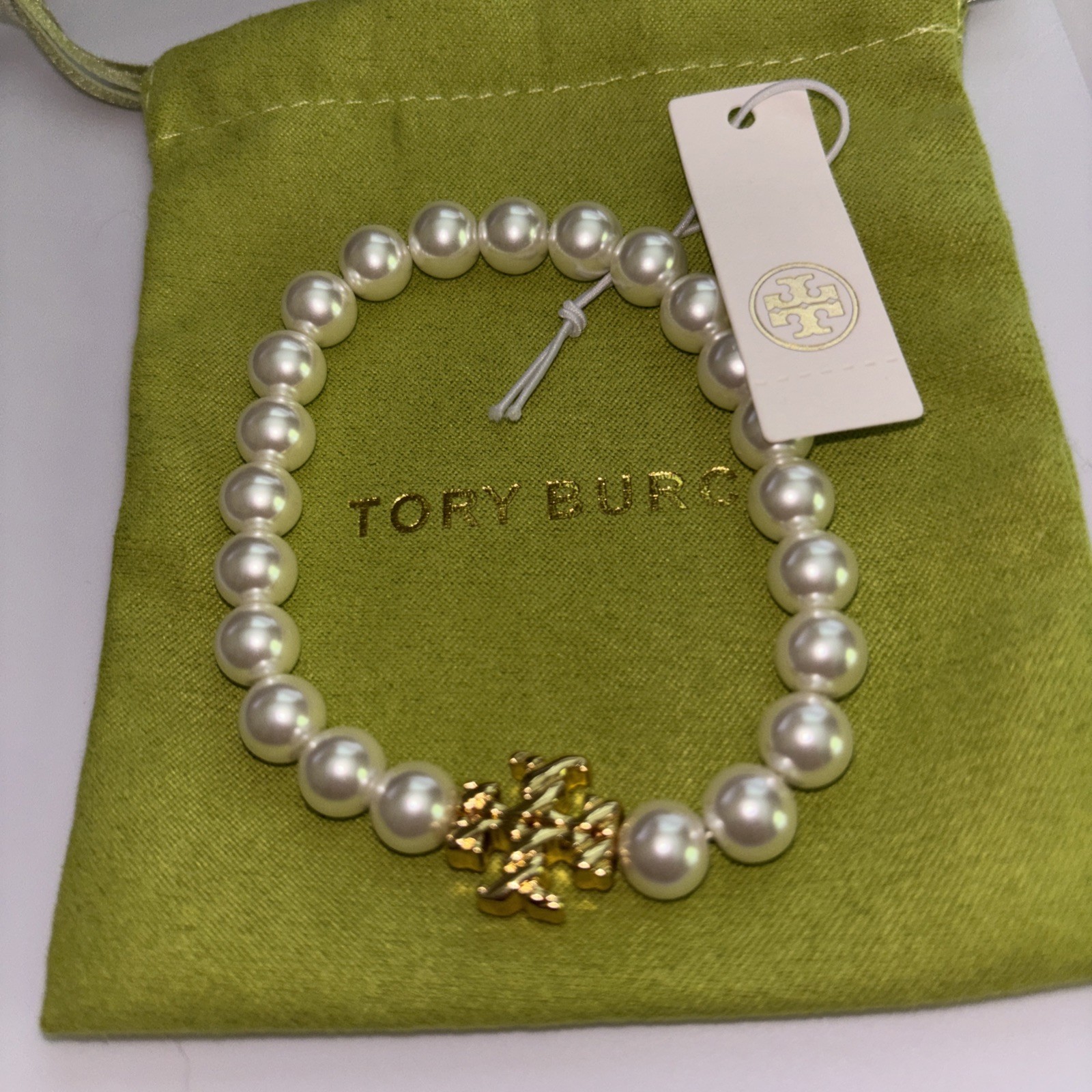 Tory Burch Pearl Bracelet with gold Kira logo.